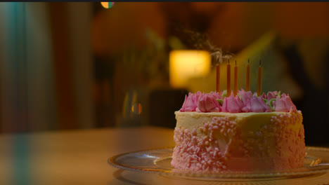 Candles-Being-Blown-Out-On-Party-Celebration-Cake-For-Birthday-Decorated-With-Icing-On-Table-At-Home-2